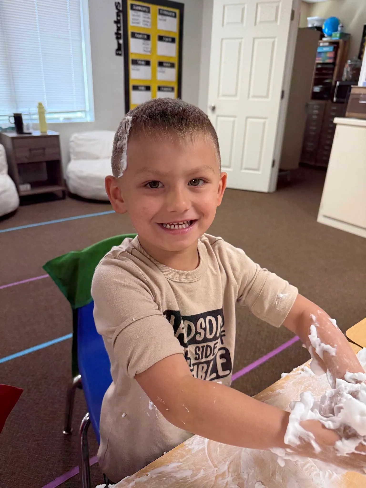 A child smiling during a hands-on sensory activity